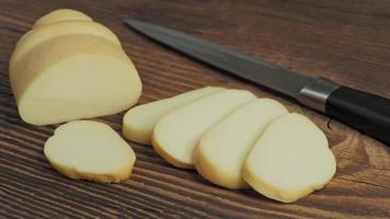 Smoked cheese on wooden background video