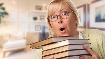 Beautiful Expressive Student or Businesswoman with Books in Office. photo