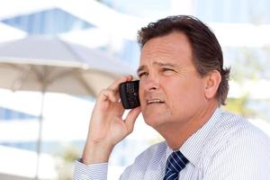 Businessman Smiles as He Talks on His Cell Phone photo