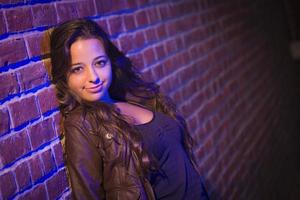 Pretty Mixed Race Young Adult Woman Against a Brick Wall photo