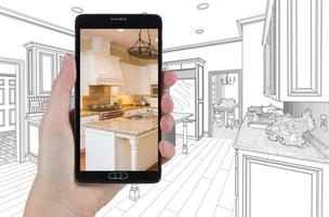 Hand Holding Smart Phone Displaying Photo of Kitchen Drawing Behind.