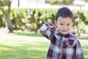 Mixed Race Boy Playing Football Outside photo