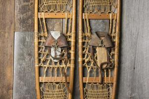 Antique Snowshoes on Rustic Cabin Wall photo