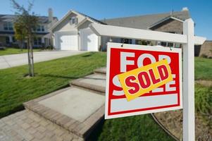 Sold Home For Sale Sign and House photo