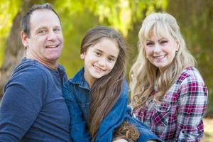 Caucasian Grandmother and Grandfather With Young Mixed Race Grandaughter Outdoors photo