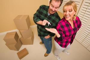 Goofy Excited Man Handing Keys to Smiling Wife photo