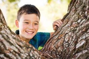 Outdoor portrait of a biracial Chinese and Caucasian boy. photo