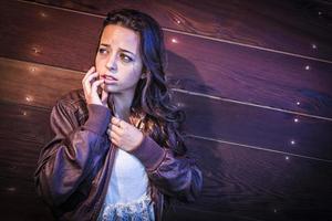 Frightened Pretty Young Woman in Dark Walkway at Night photo