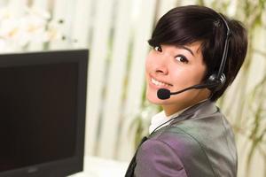 Attractive Young Woman Smiles Wearing Headset photo