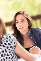 Concerned Young Adult Woman Talking With Her Friend photo