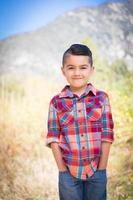 Mixed Race Young Boy Standing Outdoors. photo