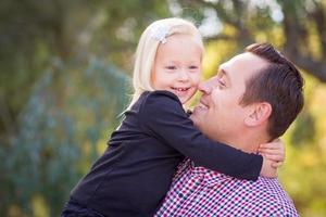 Young Caucasian Father and Daughter Having Fun At The Park photo