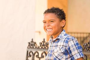 Handsome African American and Mexican Boy Sitting on Park Bench photo