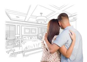 Young Military Couple Looking Over Custom Bedroom Design Drawing photo