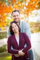 Outdoor Fall Portrait of Chinese and Caucasian Young Adult Couple. photo