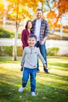 Outdoor Portrait of Happy Mixed Race Chinese and Caucasian Parents and Child. photo