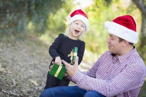 Father Giving Young Daughter Christmas Gift photo