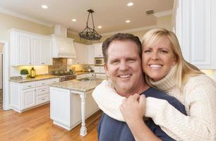 Happy Couple Inside Beautiful Custom Kitchen photo