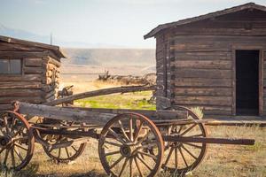 Abstract of Vintage Antique Wood Wagon and Log Cabins. photo