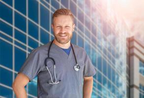 Caucasian Male Nurse In Front Of Hospital Building photo