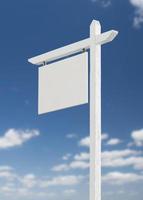 Blank Real Estate Sign Over A Blue Sky with Clouds. photo