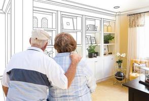 Senior Couple Facing Custom Built-in Shelves and Cabinets Design Drawing Gradating to Finished Photo