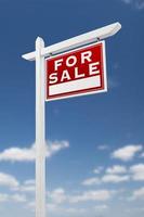 Right Facing For Sale Real Estate Sign on a Blue Sky with Clouds. photo