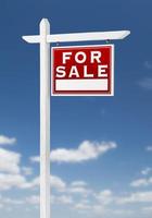 Right Facing For Sale Real Estate Sign on a Blue Sky with Clouds. photo