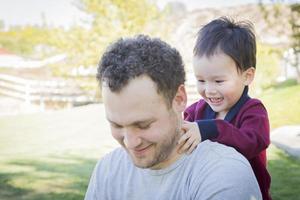 Caucasian Father Having Fun with His Mixed Race Baby Son photo