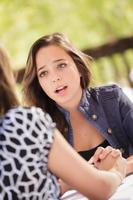 Concerned Young Adult Woman Talking With Her Friend photo