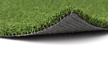 Flipped Up Section of Artificial Turf Grass On White Background photo