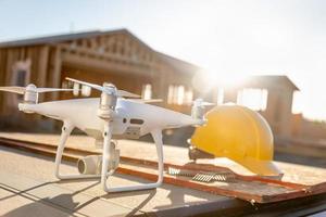 Drone Quadcopter Next to Hard Hat Helmet At Construction Site photo
