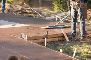 Construction Worker Smoothing Wet Cement With Trowel Tool photo