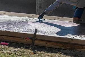 Construction Worker Smoothing Wet Cement With Trowel Tools photo