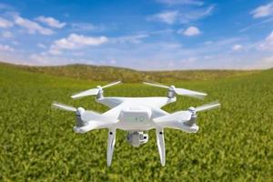 Drone Unmanned Aircraft Flying and Gathering Data Over Country Farmland photo