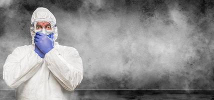 Man Wearing Hazmat Suit and Goggles In Smokey Room Banner with Copy Space photo