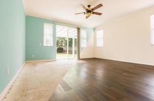 Empty Room with Cross Section Showing Before and After With New Wood Floor and Paint photo