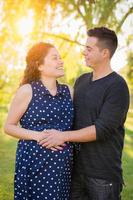 Hispanic Pregnant Young Couple Portrait Outdoors photo