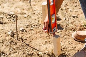 Worker Using Level At Construction Site photo