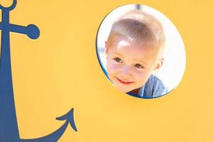 Happy Young Boy Having Fun At The Playground photo