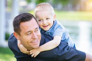 Young Caucasian Father and Son Having Fun At The Park photo