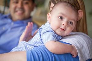 Happy Attractive Mixed Race Couple Burping Their Son photo