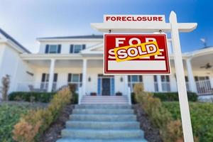 Left Facing Foreclosure Sold For Sale Real Estate Sign in Front of House. photo