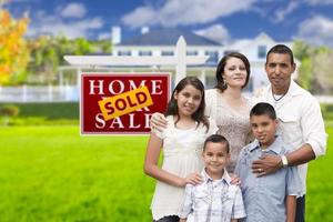 Hispanic Family in Front of Sold Real Estate Sign, House photo