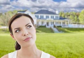 Thoughtful Mixed Race Woman In Front of House photo