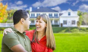 Happy Mixed Race Couple in Front of House photo