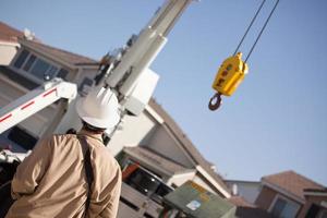 Utility Worker Navigating Remote Crane photo