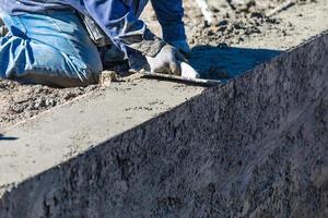 Pool Construction Worker Working With Wood Float On Wet Concrete photo