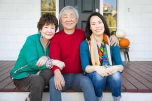 Happy Chinese Senior Adult Mother and Father with Young Adult Daughter photo