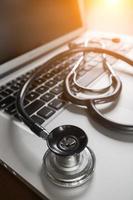 Medical Stethoscope Resting on Laptop Computer Keyboard. photo